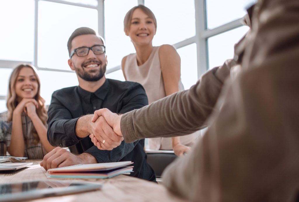 client shaking hands with business team